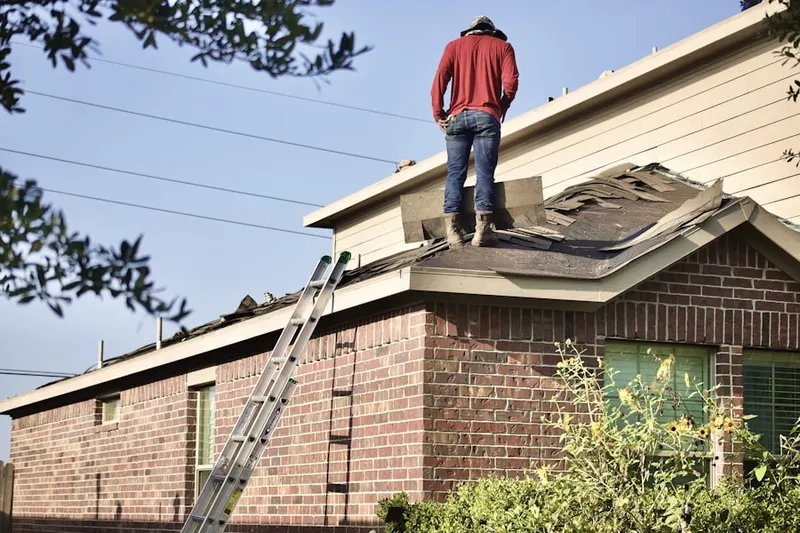 Professional roofer working on a residential roof in Gulfport